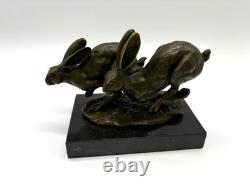 Sculpture of running hares in bronze on a black marble base after Nick