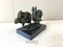 Sculpture of running hares in bronze on a black marble base after Nick