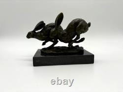 Sculpture of running hares in bronze on a black marble base after Nick