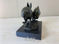 Sculpture of running hares in bronze on a black marble base after Nick