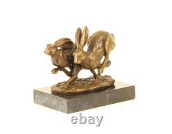 Sculpture of running hares in bronze on black marble after Nick