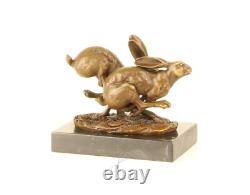 Sculpture of running hares in bronze on black marble after Nick