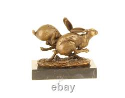 Sculpture of running hares in bronze on black marble after Nick