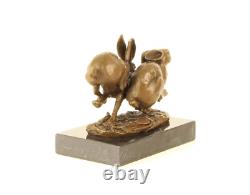 Sculpture of running hares in bronze on black marble after Nick