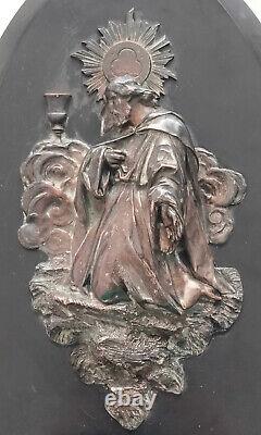Wall-mounted bronze sculpture signed on a marble plaque