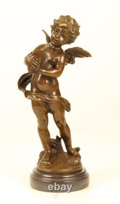 Sculpture d'un Putto jouant la Cymbales en bronze sur un marbre noir signée