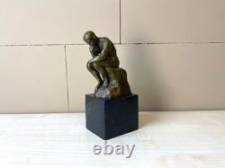 Sculpture en bronze Le Penseur sur un marbre noir d'après Auguste Rodin